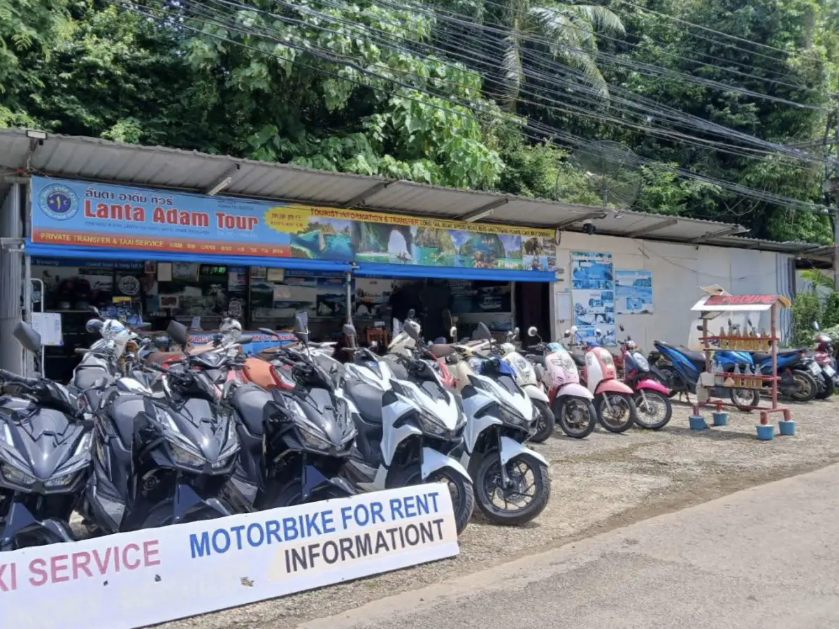 The Lanta Adam Tour shop front with its blue sign and rows of rental scooters